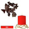 A red candle in a gold holder next to dark brown dye blocks.