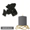 Brown black candle dye blocks next to a gold-wired pillar candle.