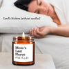 A glass candle jar with a lit candle and a label reading Mom's Last Nerve or look it's on fire