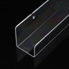 A clear acrylic floating shelf with a slanted top is shown against a black background.