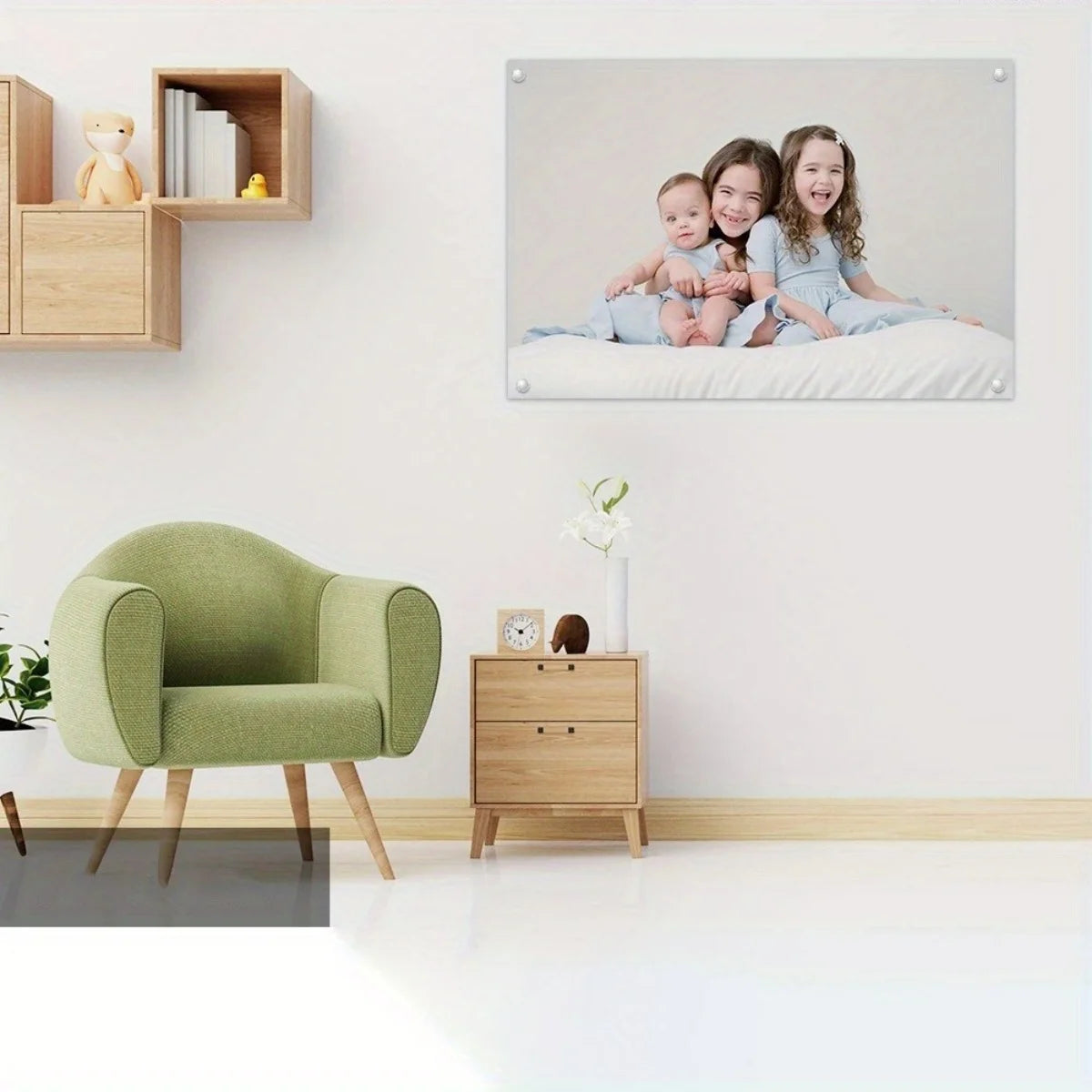 A framed canvas wall art featuring three smiling children sitting together on a white background.