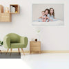 A framed canvas wall art featuring three smiling children sitting together on a white background.