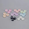 A collection of glow-in-the-dark resin ghost tree elves in various pink, green, and blue colors for fairy garden décor.