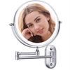 A round illuminated magnifying makeup mirror with a silver frame and adjustable arm.