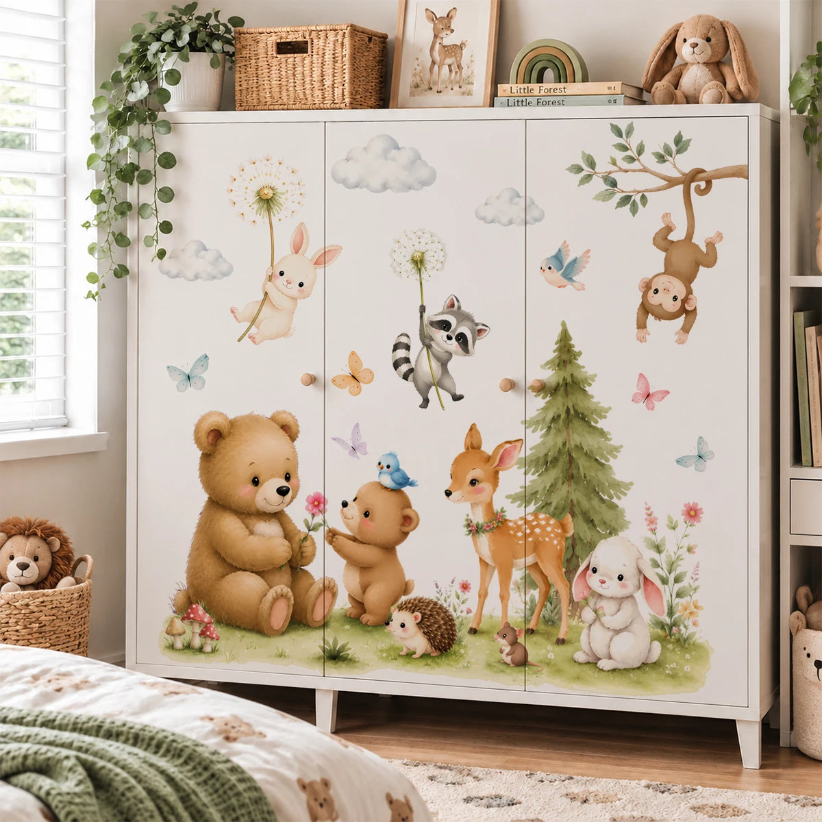A white cabinet featuring watercolor woodland forest animal decals of a bear, deer, and other forest creatures.