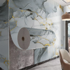 A modern interior wall featuring marble pattern self-adhesive wallpaper with gray and gold veining.
