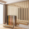 Metallic gold striped peel-and-stick wallpaper covering a wall with vertical stripes and decorative trim.