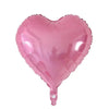 A pink heart-shaped foil balloon used for celebrations.