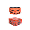 An orange, carved pumpkin shaped bowl with a menacing face and black accents.
