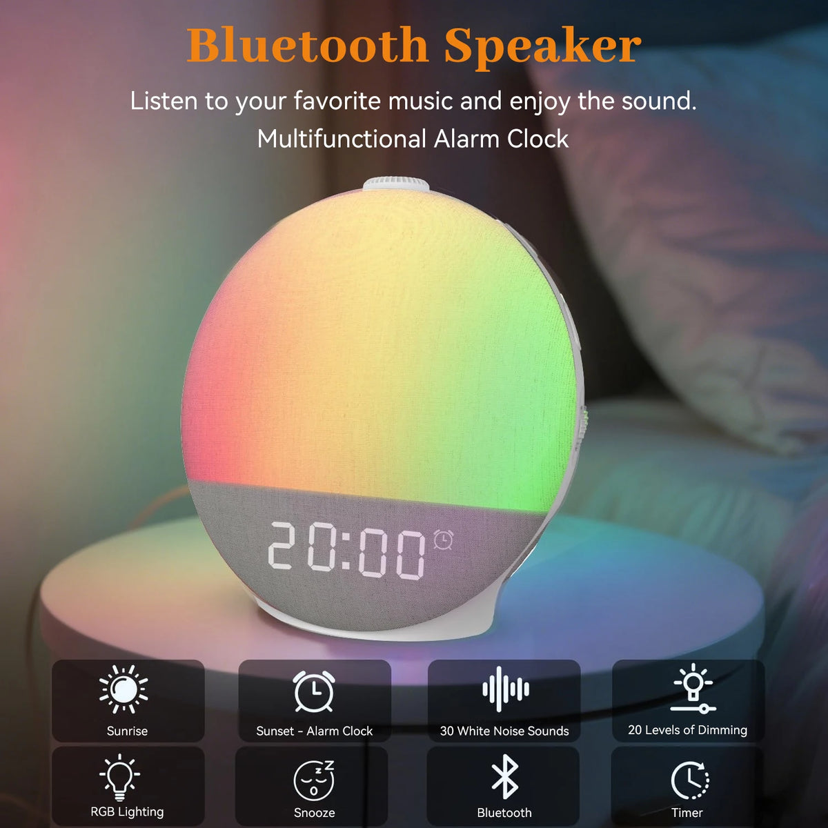 A round Bluetooth speaker with a digital display showing 20:00 and various function buttons is shown on a bedside surface.