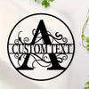 Black metal silhouette of the letter A with swirling vines inside a circular frame for custom text