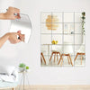 A hand is placing a self-adhesive acrylic mirror tile onto a white wall, part of a decorative grid display.