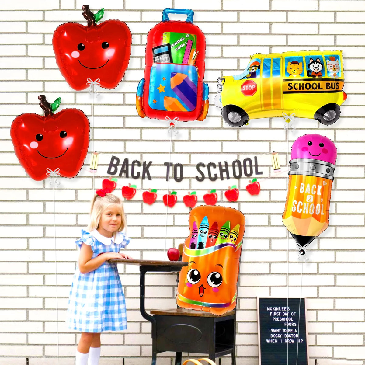 A set of six foil balloons shaped like apples and a yellow school bus for back-to-school celebrations
