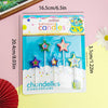 A pack of colorful star-shaped birthday candles with a crown design displayed on a light pink background.