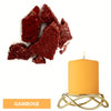 Red dye blocks used for candle making next to a golden candle holder