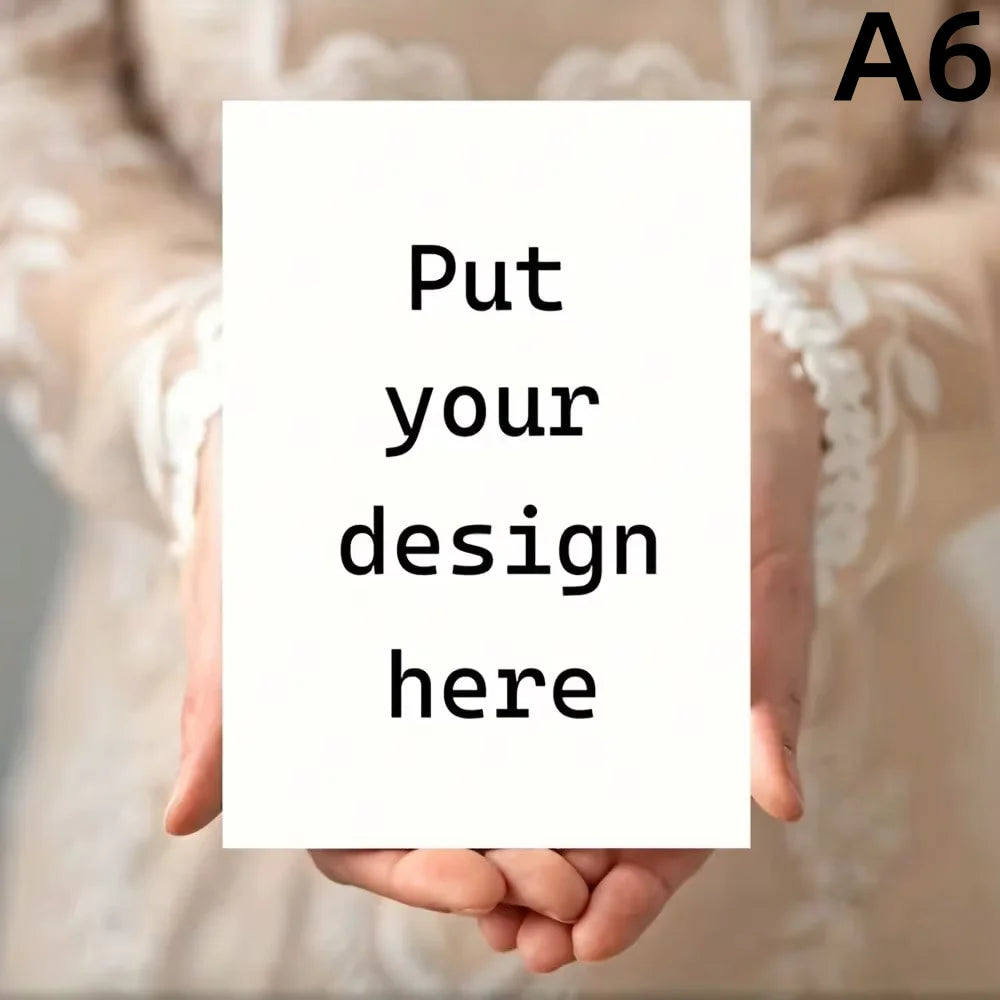 A person's hands are holding a blank white card with the text Put your design here on it.