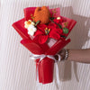 A bouquet of handmade crochet yarn flowers in orange and red nestled in a red paper wrapping.