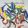 A collection of colorful 3D printed articulated lizard figurines used for home decor and holiday crafts.