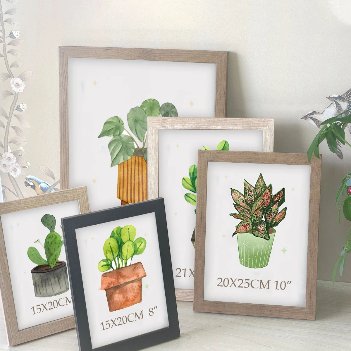 A collection of wooden photo frames displaying various green plants and foliage.