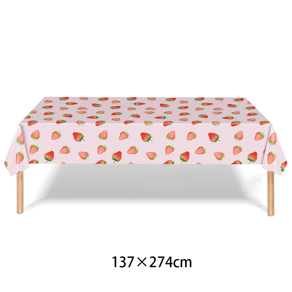 Pink strawberry patterned tablecloth measuring 137 x 274 cm for a party supplies kit