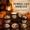 A collection of six seasonal fragrances featuring pumpkin chai scents in glass jars set against a rustic background.