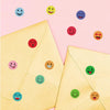 A collection of colorful round expression stickers on a pink background, including smiley faces and happy emojis.