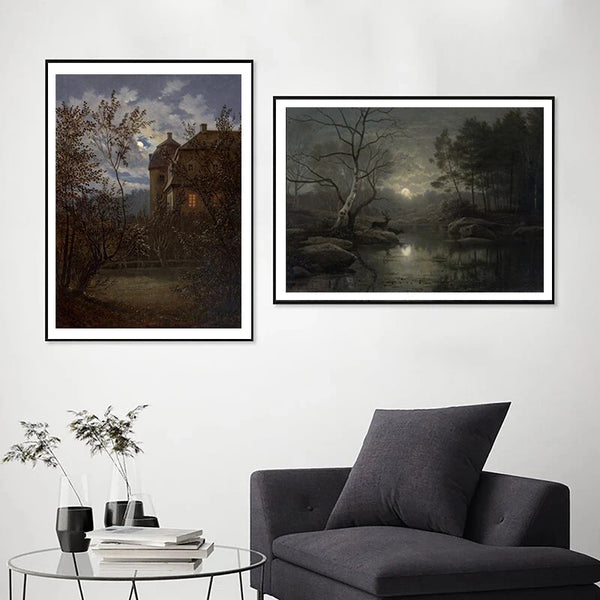 A gallery wall featuring two dark, moody paintings of landscapes and architecture.