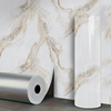 Roll of marble pattern self-adhesive wallpaper next to a vertical tube.