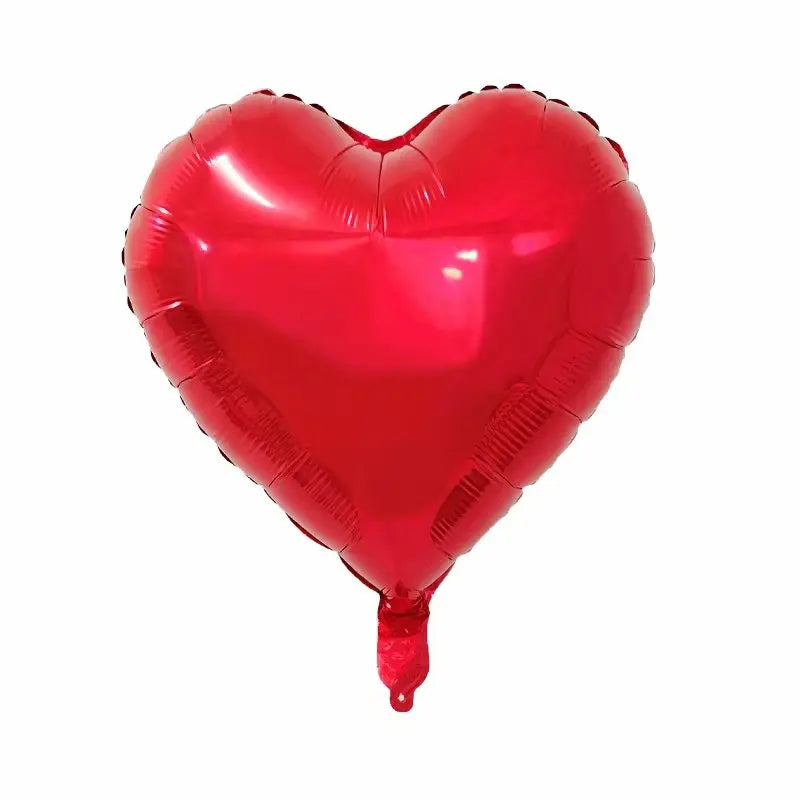A glossy red heart-shaped foil balloon used for celebrations.