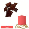 A pink candle in a gold holder with dark reddish-brown dye blocks nearby.