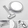 A silver illuminated double-sided magnifying makeup mirror with a handle and charging port.