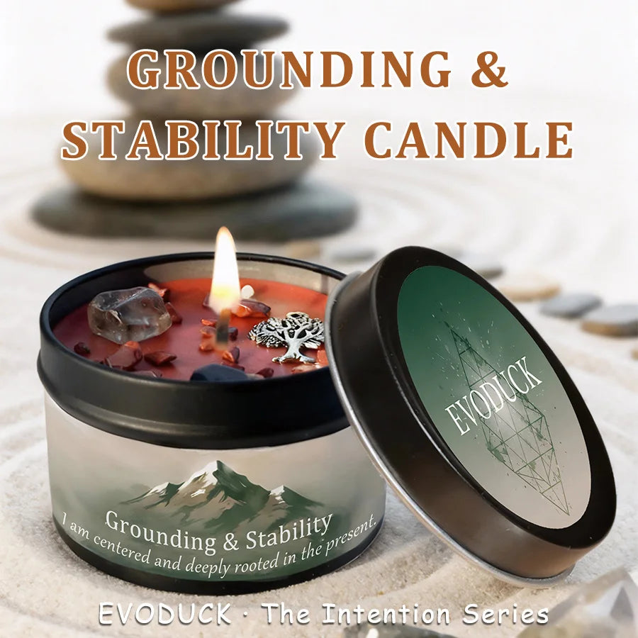 A dark jar candle labeled Grounding & Stability, with a lit wick and an open lid showing the brand EVODUCK.