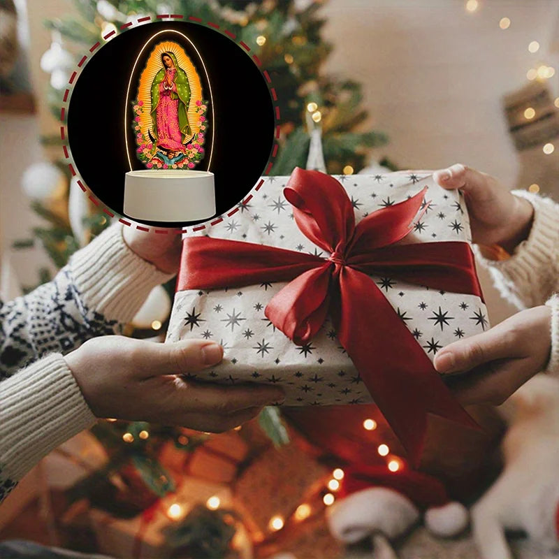 Hands present an acrylic LED night light of Our Lady of Guadalupe inside a gift box.