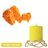 Sunny yellow candle in a gold wire holder with orange dye blocks