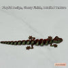 A line of small, detailed, green lizard figurines with a glossy finish displayed on a white background.