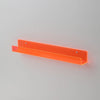 An orange clear acrylic floating shelf designed for displaying books or items.