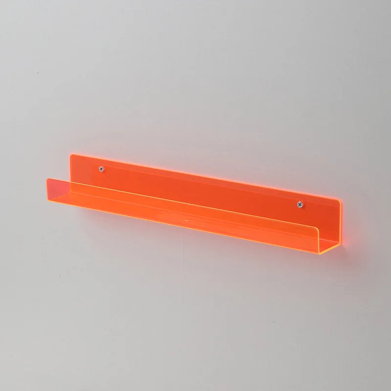 An orange clear acrylic floating shelf designed for displaying books or items.
