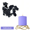 Purple blue candle in a gold wire holder next to dark purple dye blocks
