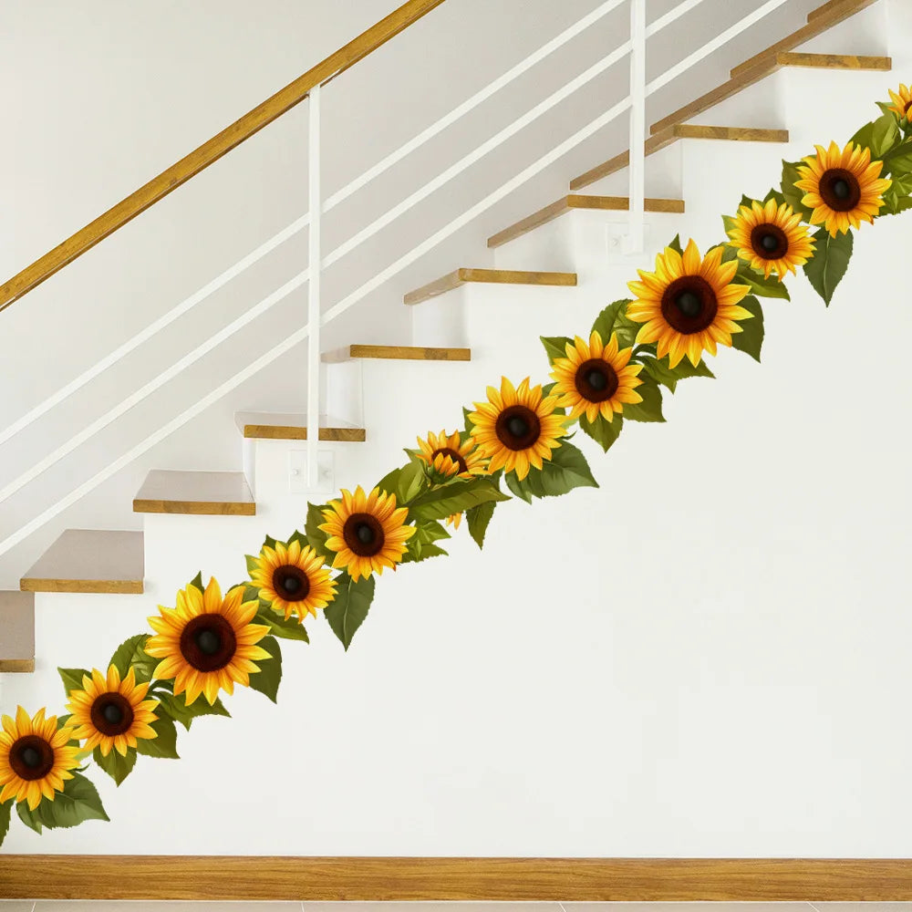 A staircase decorated with a garland of yellow sunflowers and green leaves.