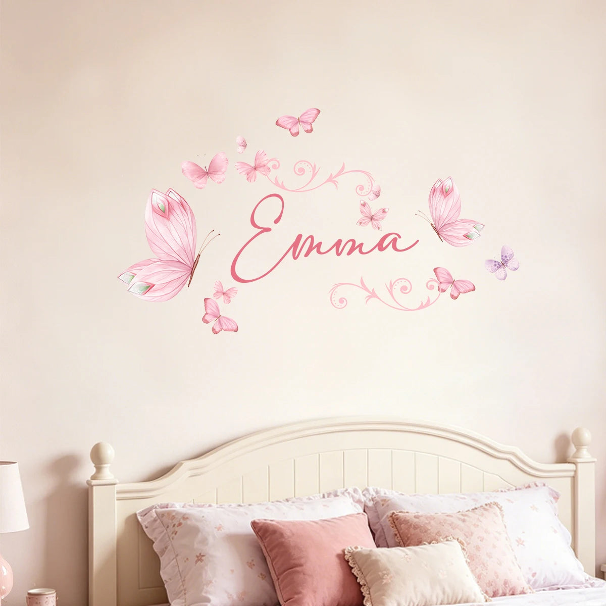 A wall sticker featuring a watercolor design of the name Emma written in pink script surrounded by pink butterflies.