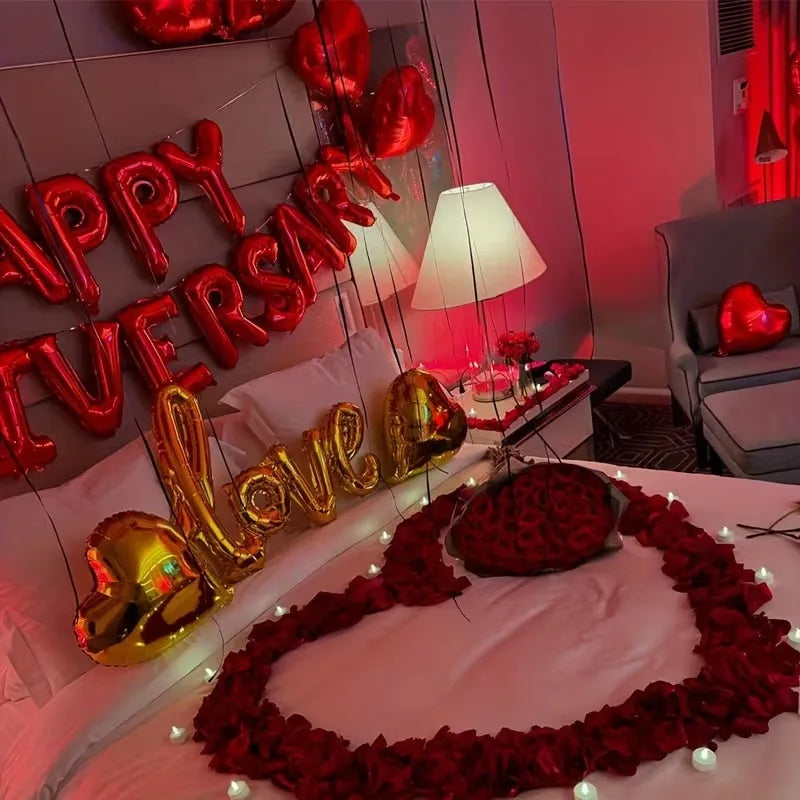 A display of red and gold heart decor, including lettering and a wreath, set against a pink background.