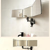 A wall-mounted mirror with three adjustable sections and an LED light is installed above a bathroom sink.