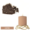 A lit candle in a gold wire holder, next to a dark coffee-colored dye block.