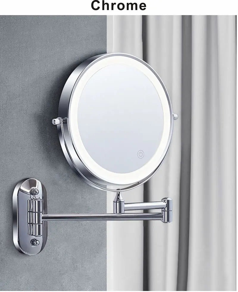 A round chrome magnifying makeup mirror is mounted on a wall with a silver arm.