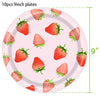 A pink plate with ten fresh strawberries arranged on it, used for party supplies.