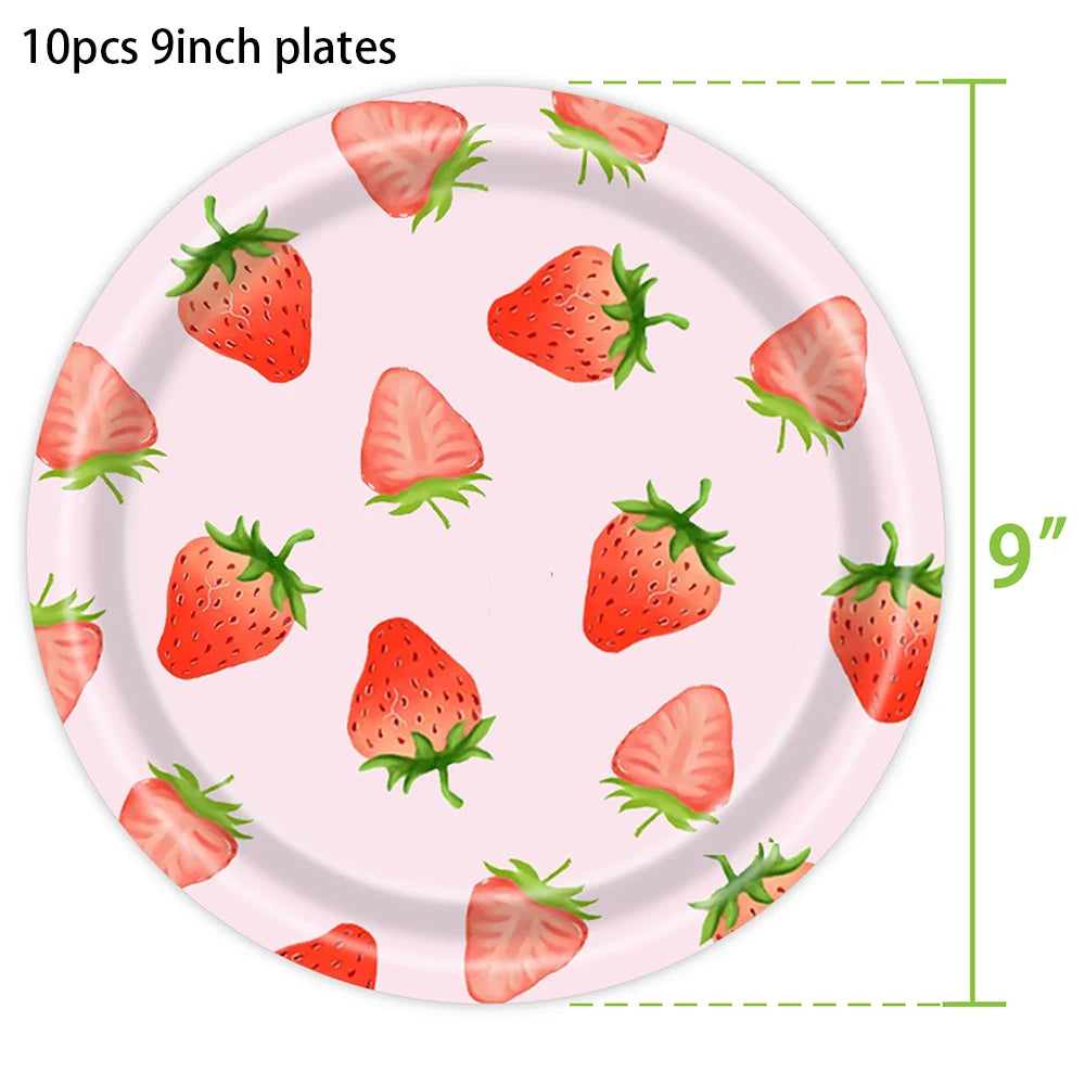 A pink plate with ten fresh strawberries arranged on it, used for party supplies.