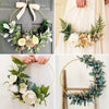 A collection of ten gold metal hoop centerpieces featuring floral greenery and roses.