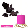 Pink candle in a gold stand with dark purple dye blocks scattered nearby
