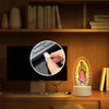 Acrylic LED night light of Our Lady of Guadalupe with USB power displayed on a wooden shelf.