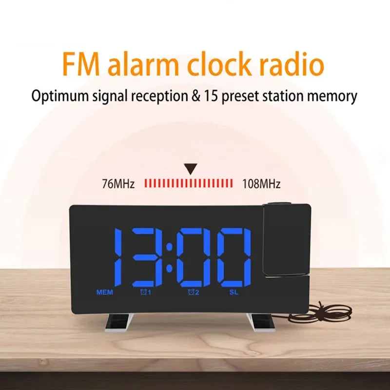 A black projection alarm clock with a large blue LED display showing 13:00 and FM radio tuning options.